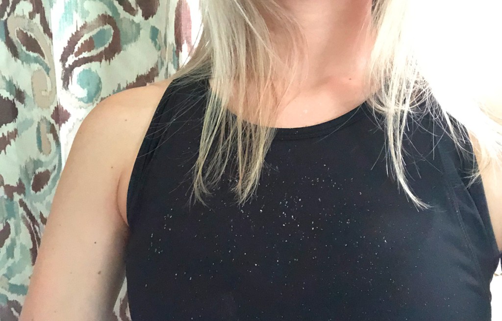 white dry shampoo residue on black tank top