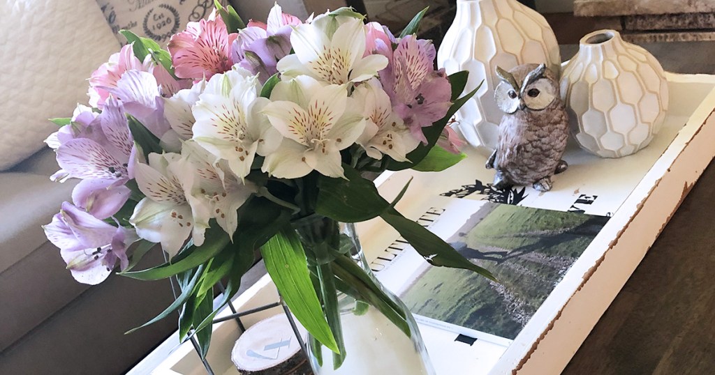 arrangement of flowers and decor on coffee table