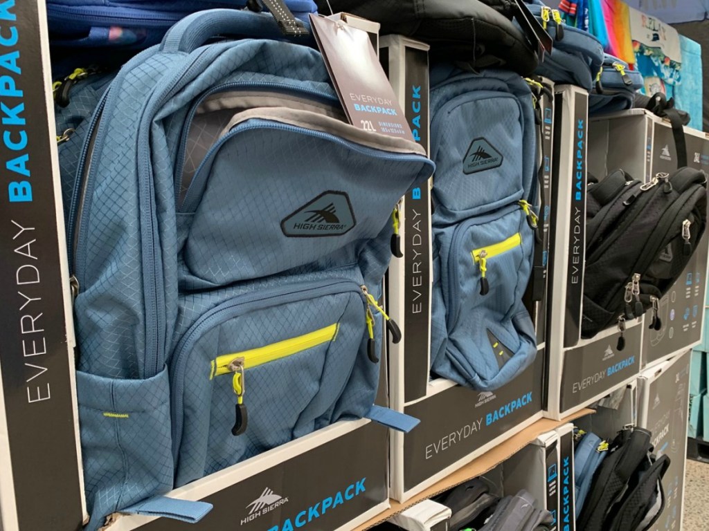 display of blue and black backpacks in store