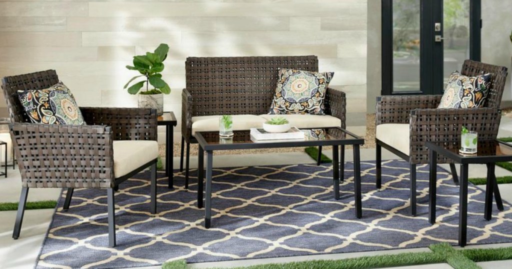 table and chairs with loveseat on outdoor rug