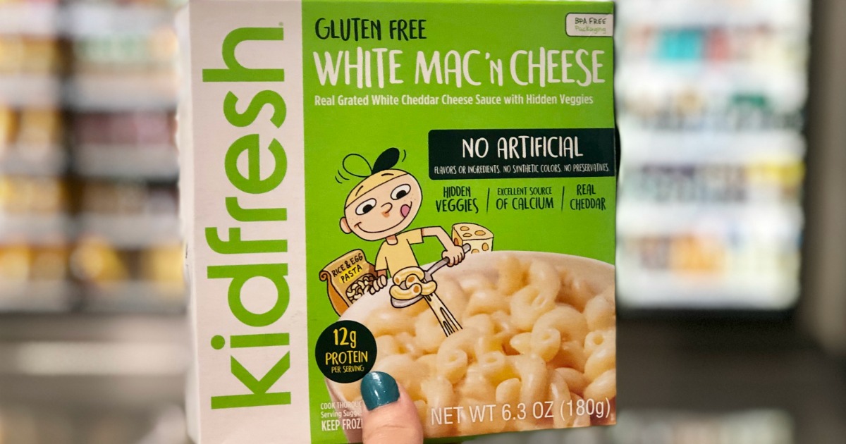 kidfresh frozen meal being held in front of store cooler door