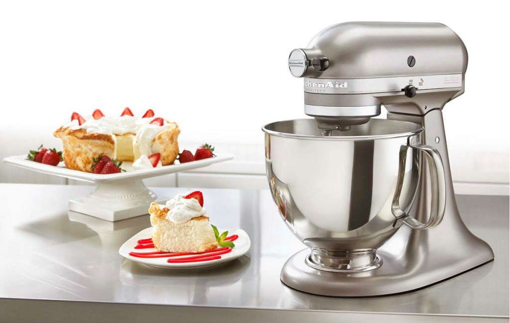 kitchenaid architect series stand mixer sitting next to cake