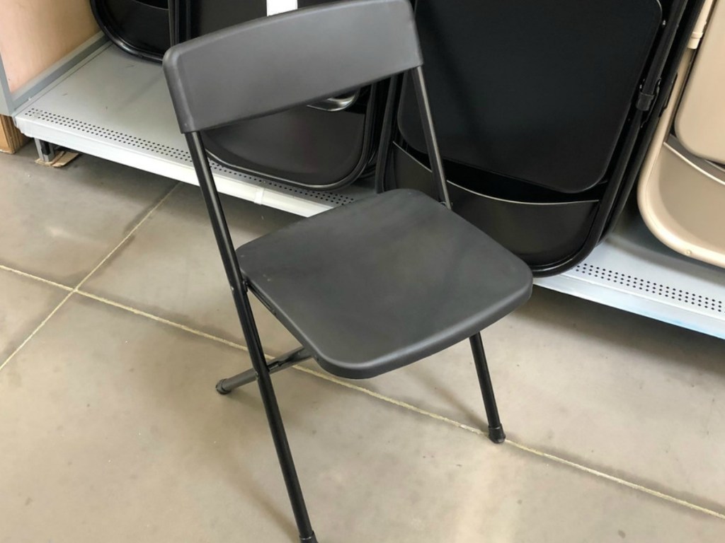 black folding chair by store display