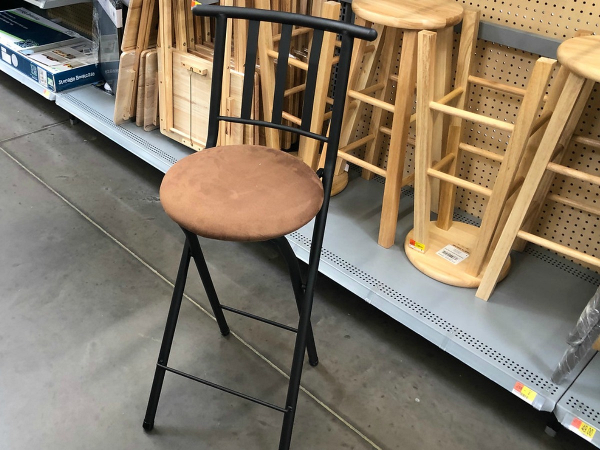 brown and black stool by store dislay in Walmart