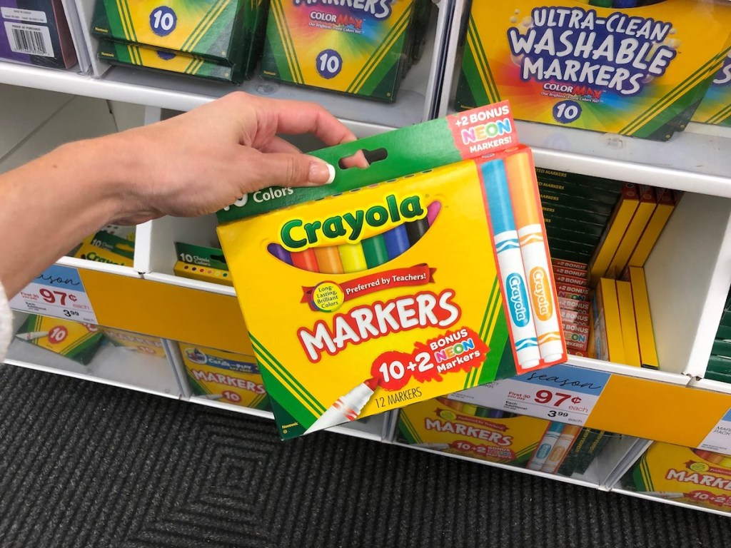 Hand holding a bonus pack of Crayola markers