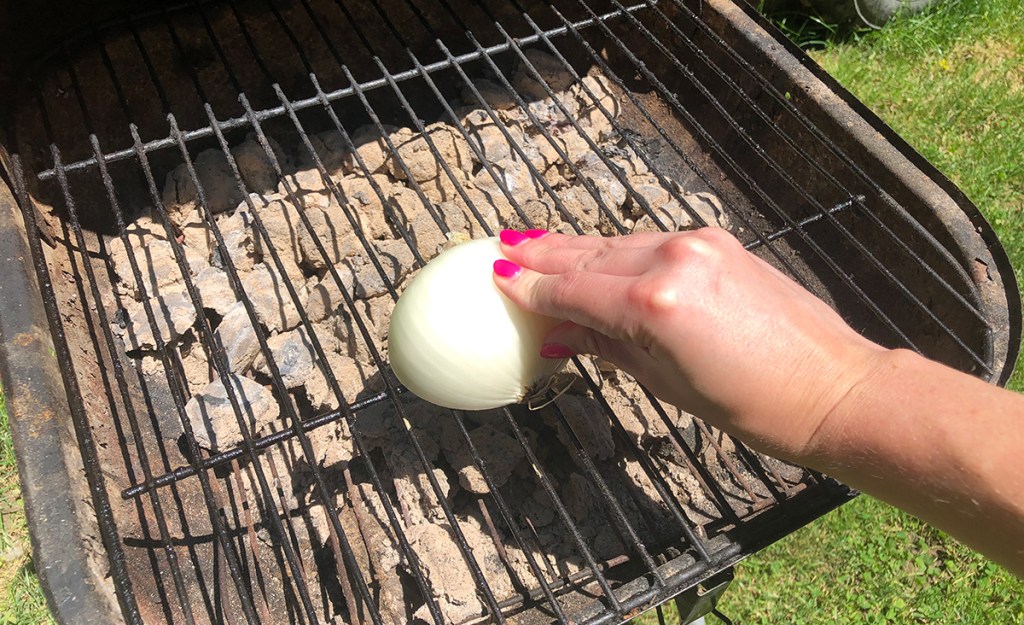 rubbing onion on grill grates