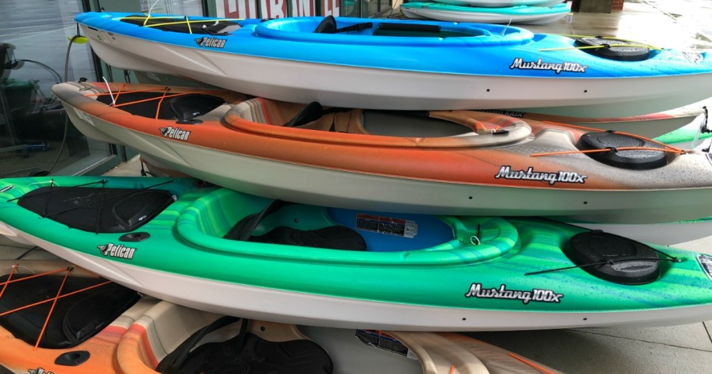 four kayaks sitting outside a store