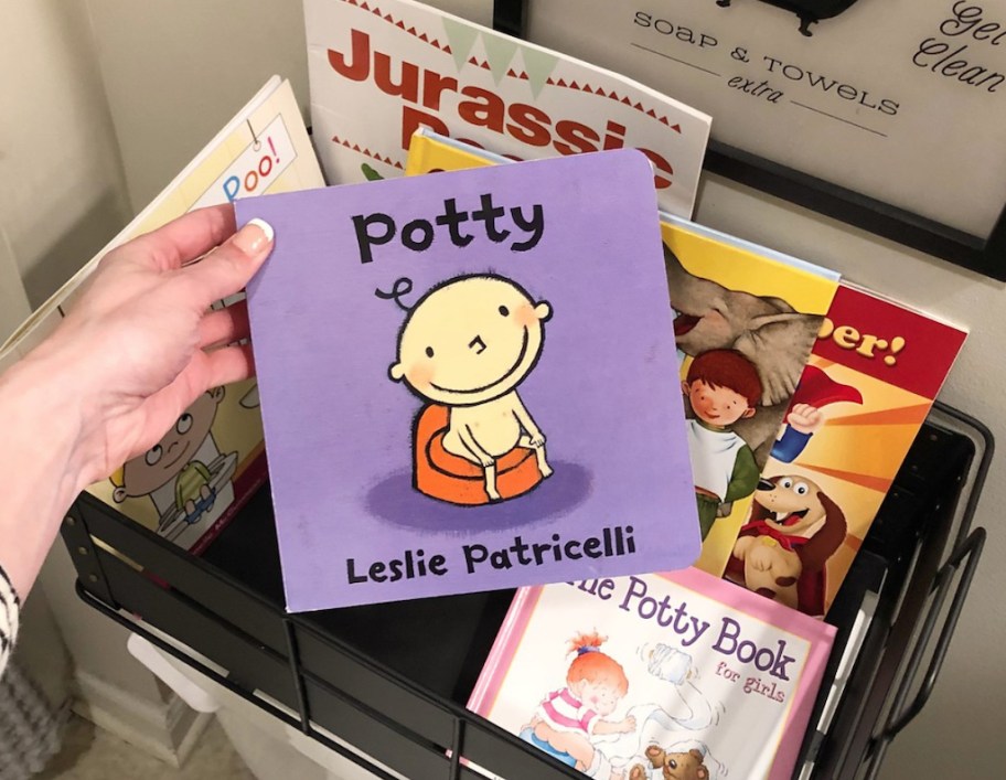 holding potty book full of potty training tips