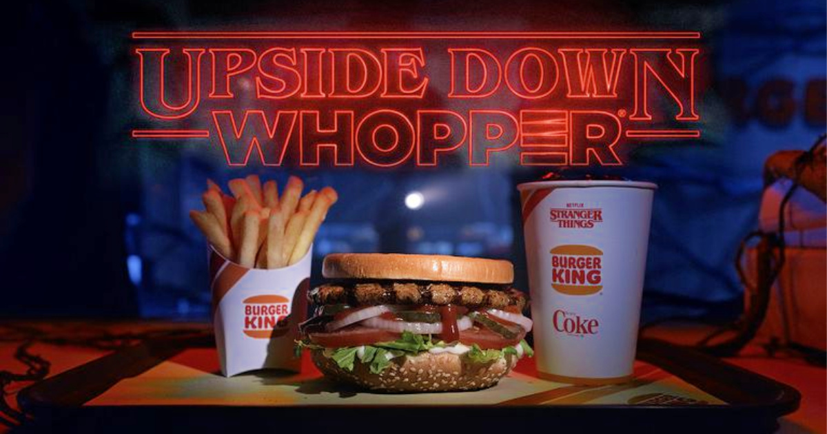 burger king upside down whopper, small fry, and small coke on tray with neon light sign