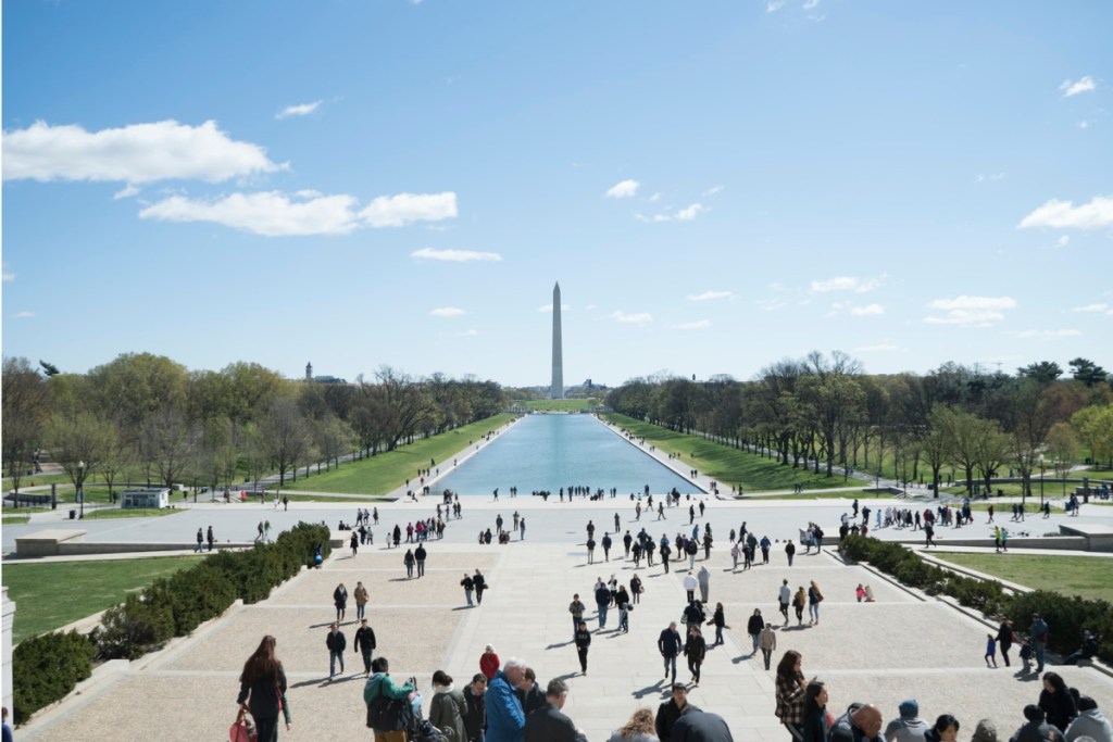 people walking in front of the washington monument