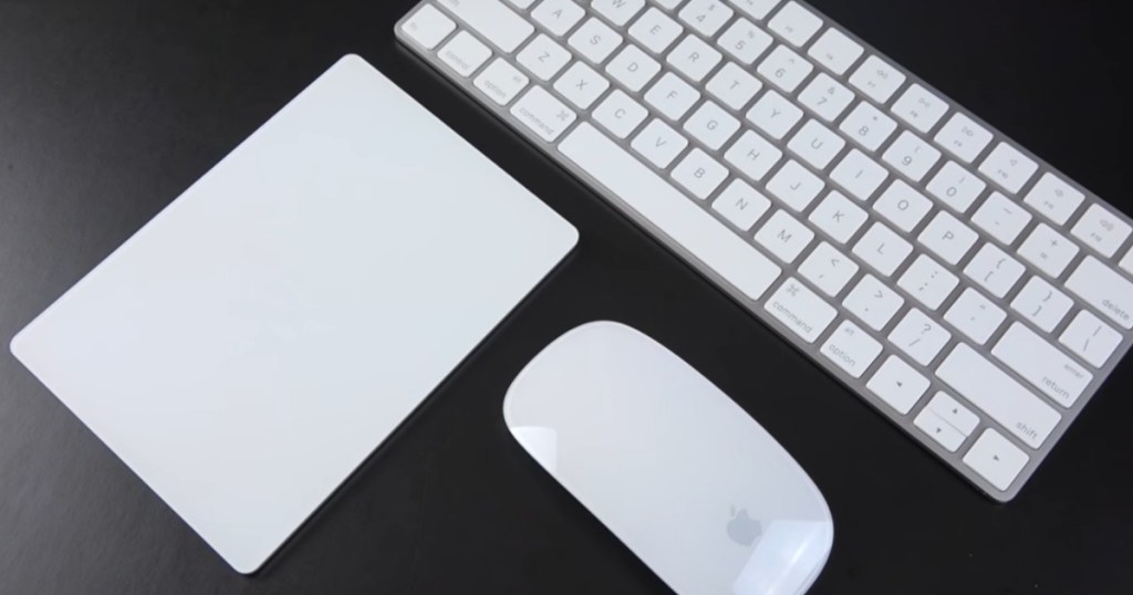 Apple Magic Trackpad 2 with apple keyboard and mouse next to it on desk