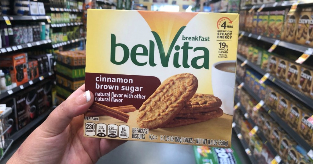 Hand holding up Belvita Breakfast Biscuits in store aisle