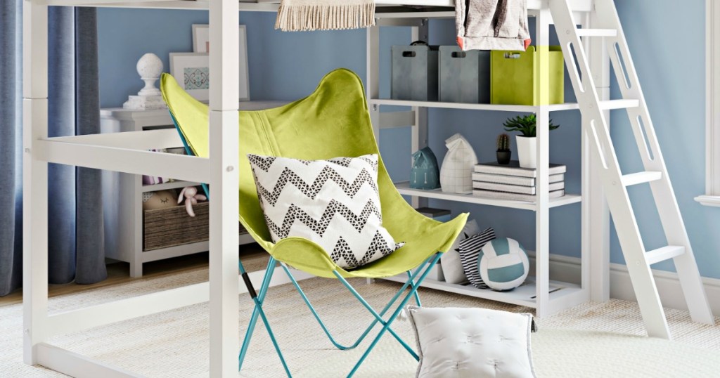 white loft bed in bedroom with green chair under loft bed