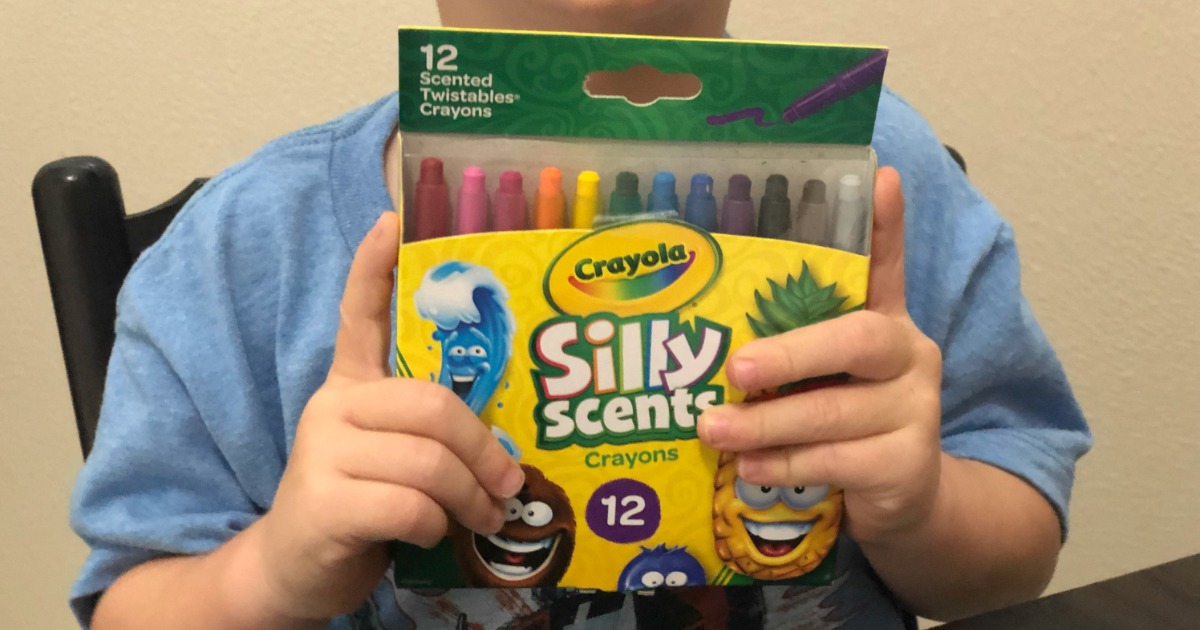 kid holding silly scents crayons