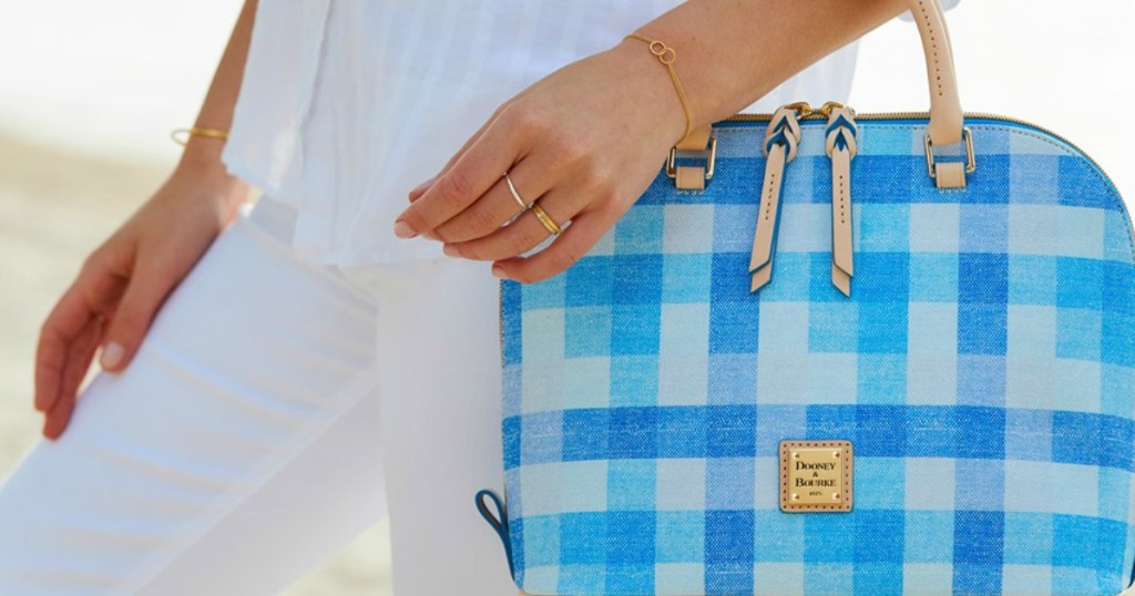 woman holding Dooney & Bourke purse