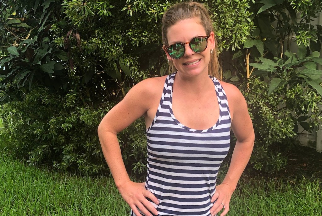 woman wearing green lens sunglasses and stripe shirt outside