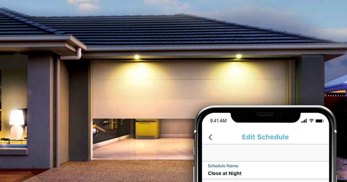 a house with lights in front of a garage and a phone