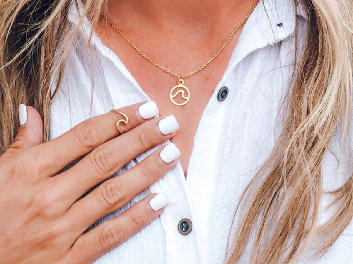 woman wearing gold wave ring