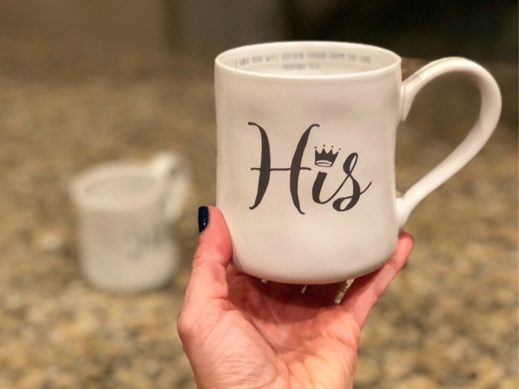 His hand-thrown Coffee Mug held up above countertop