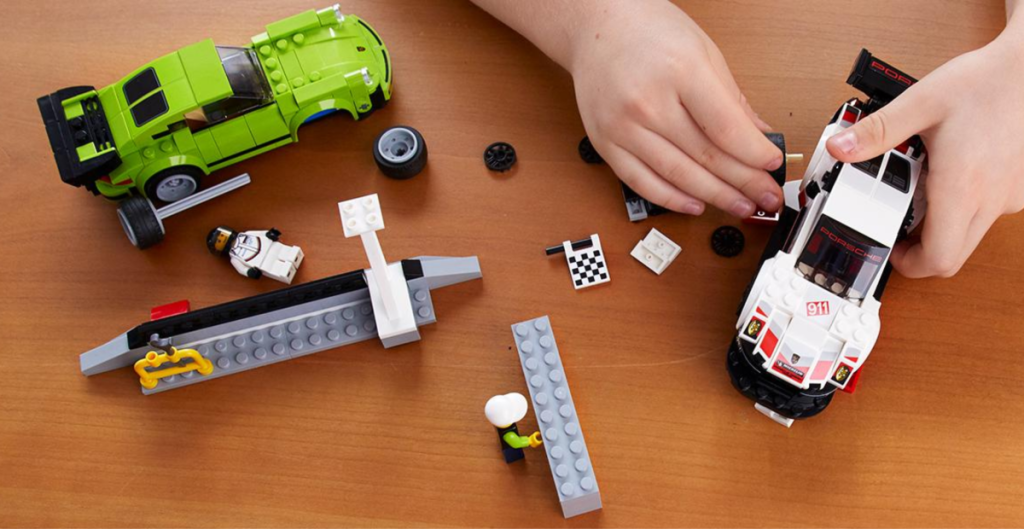 Child playing with a LEGO Speed Champions Porsche Turbo Building Kit