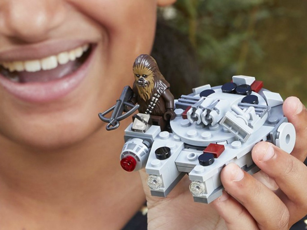 LEGO Star Wars Millennium Falcon Microfighter in child's hand close up