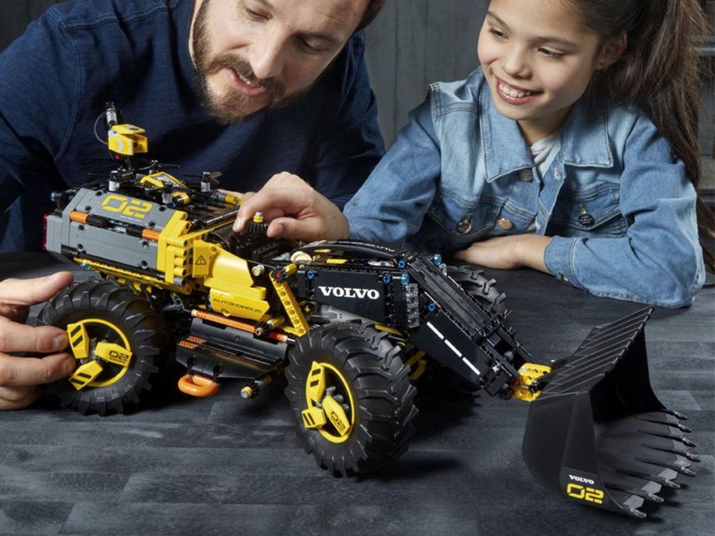 man and child playing with LEGO Technic Volvo Concept Wheel Loader