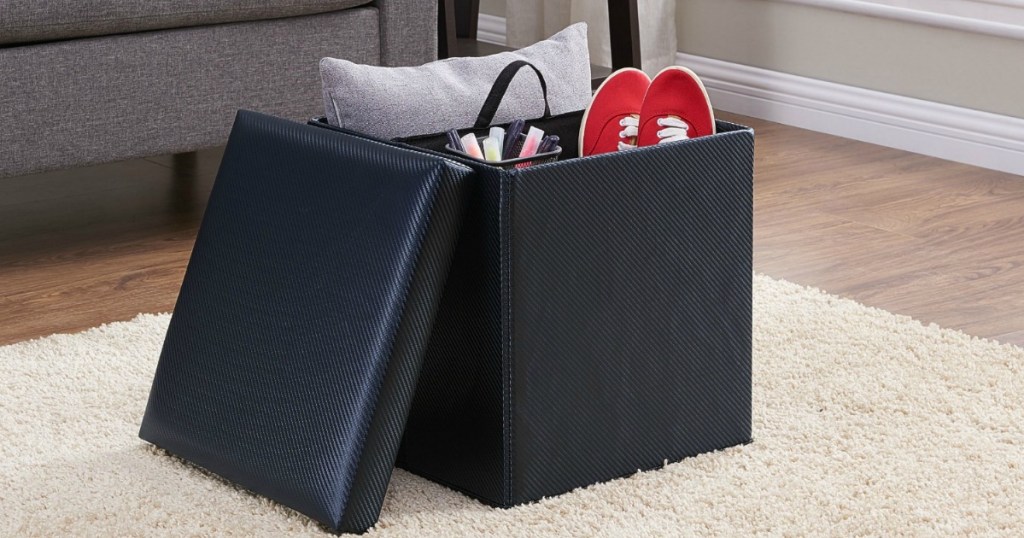 black storage ottoman filled with items