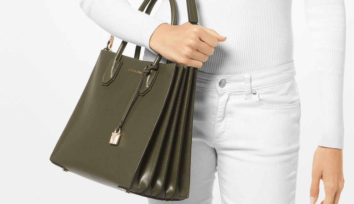 woman holding Michael Kors bag