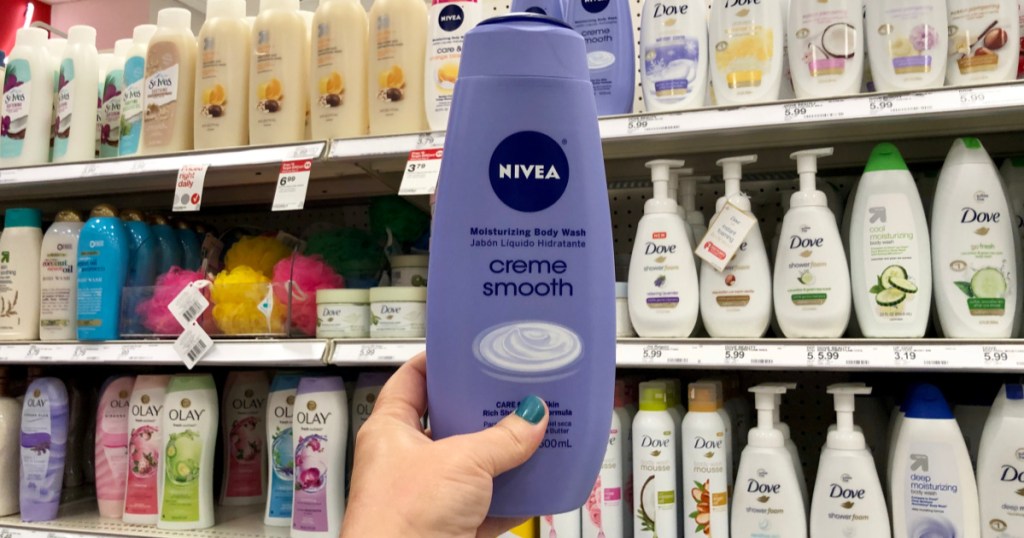 woman holding bottle of nivea body wash at target