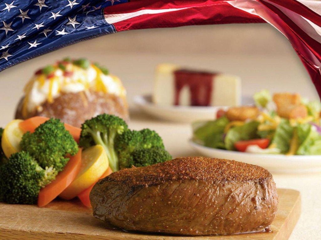 Outback steak with broccoli, carrots, baked potato, and salad