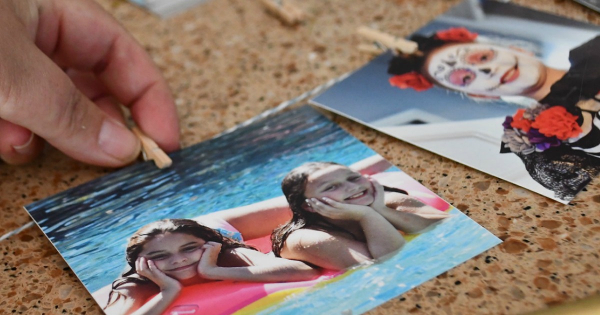 photos hanging on rope with clothespin 