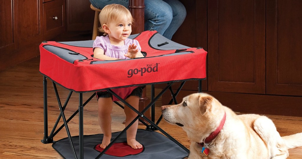 Baby sitting in portable playpod