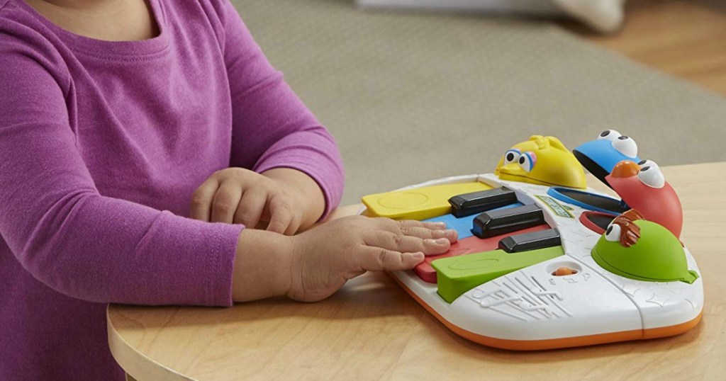 child playing Sesame Street toy piano