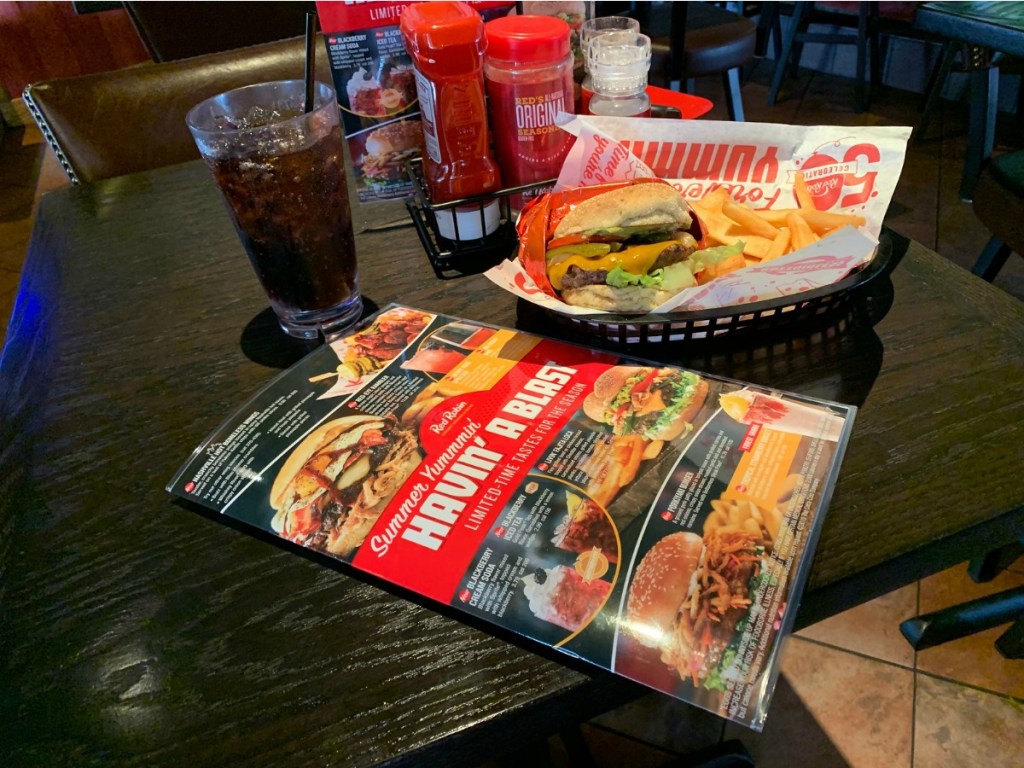 red Robin table covered with menu, burger, and drink