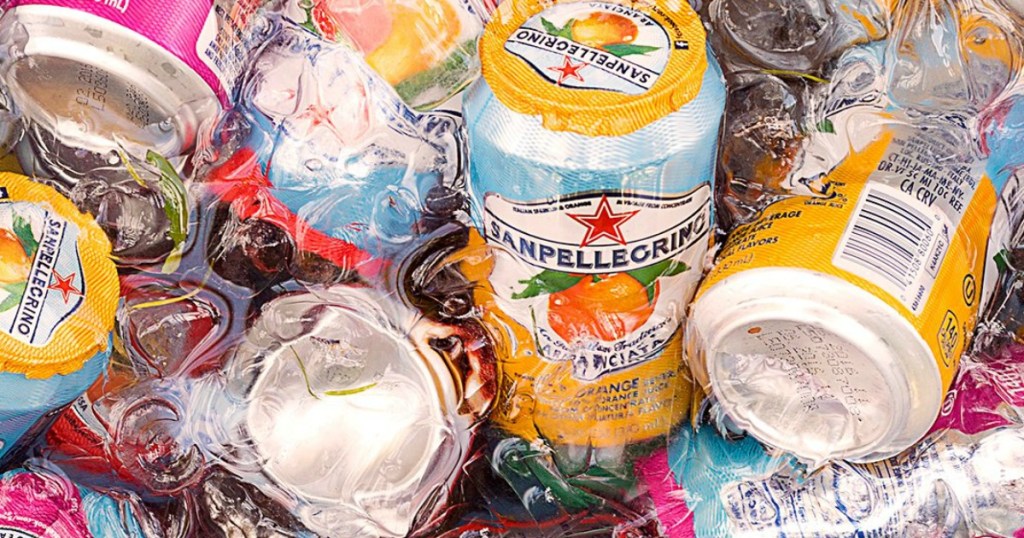 Cans of San Pellegrino Sparkling fruit juice in ice water