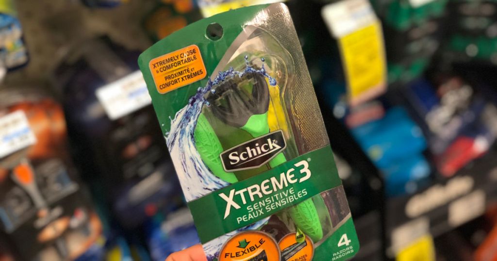 hand holding up schick xtreme3 razors at cvs