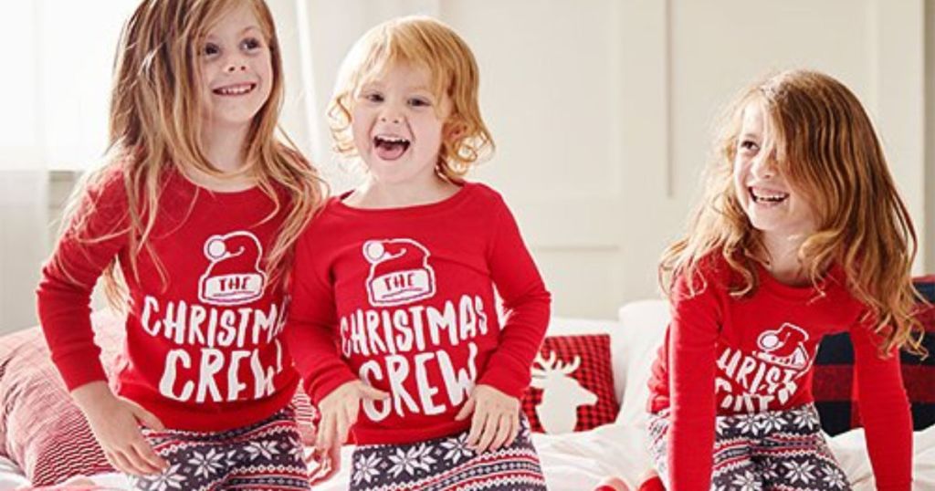 three girls wearing the christmas crew pajamas