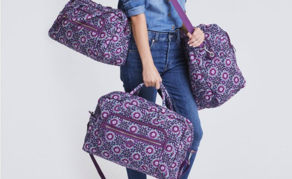 woman carrying several Weekender totes