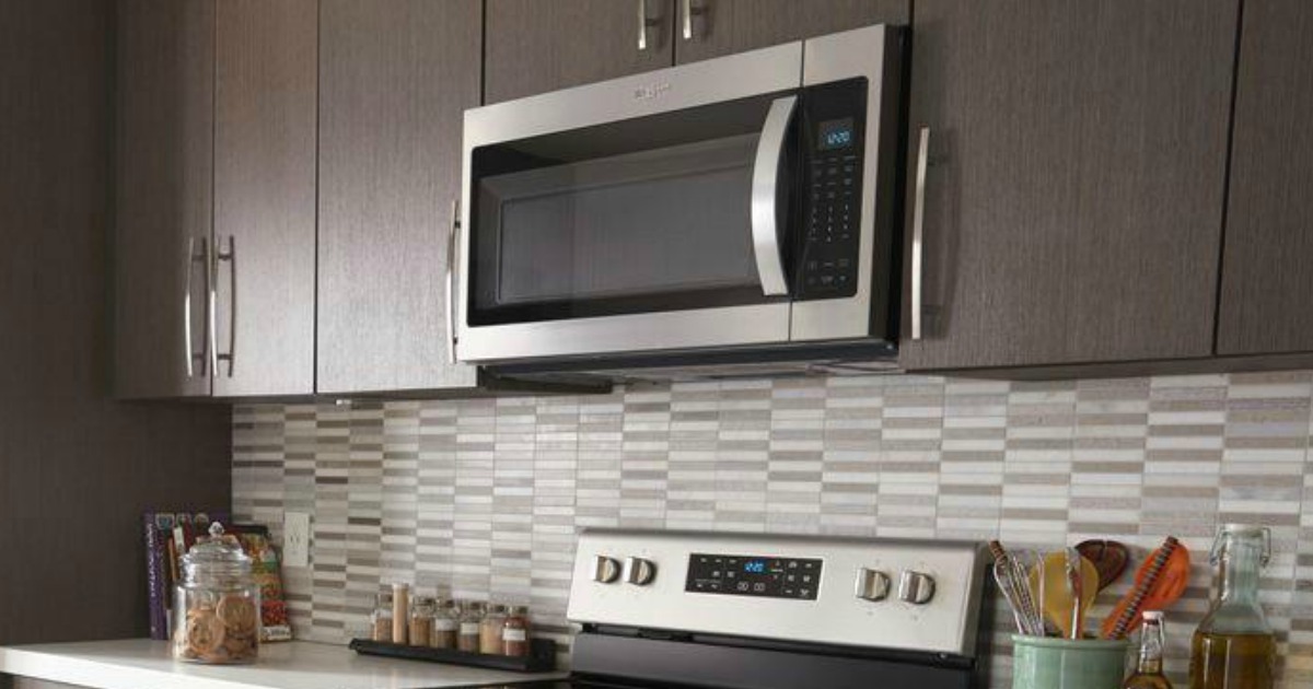 microwave oven built into cabinets above a stove