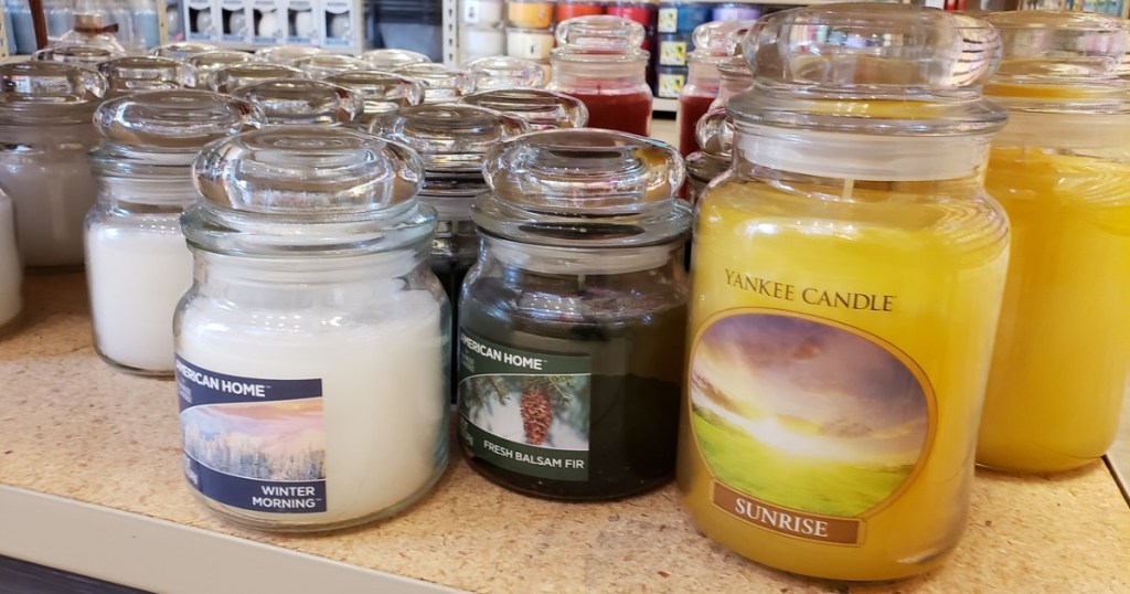 multiple yankee candles on shelf at store