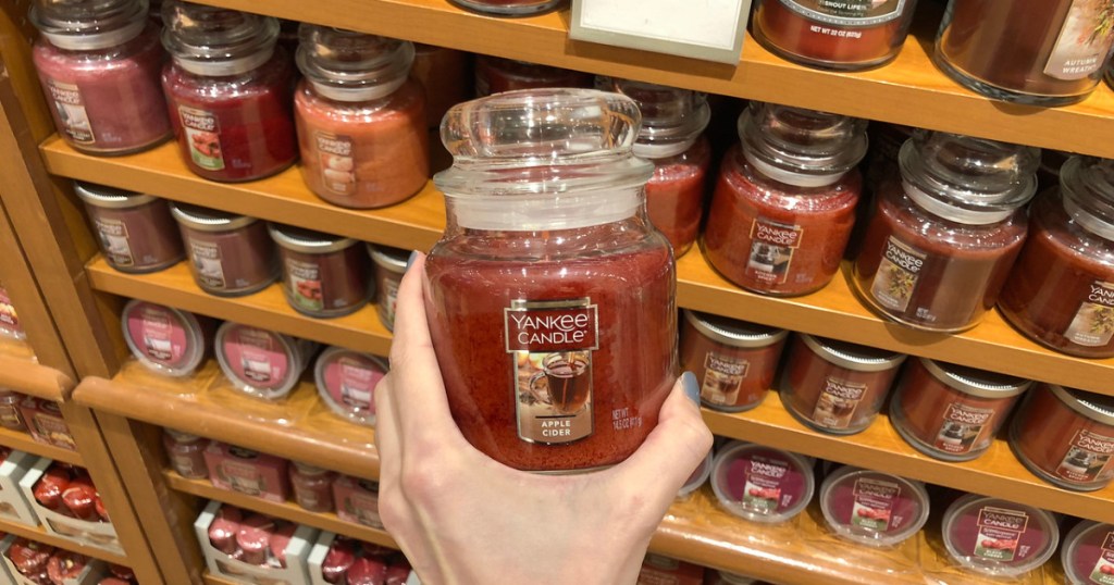 hand holding a medium yankee candles