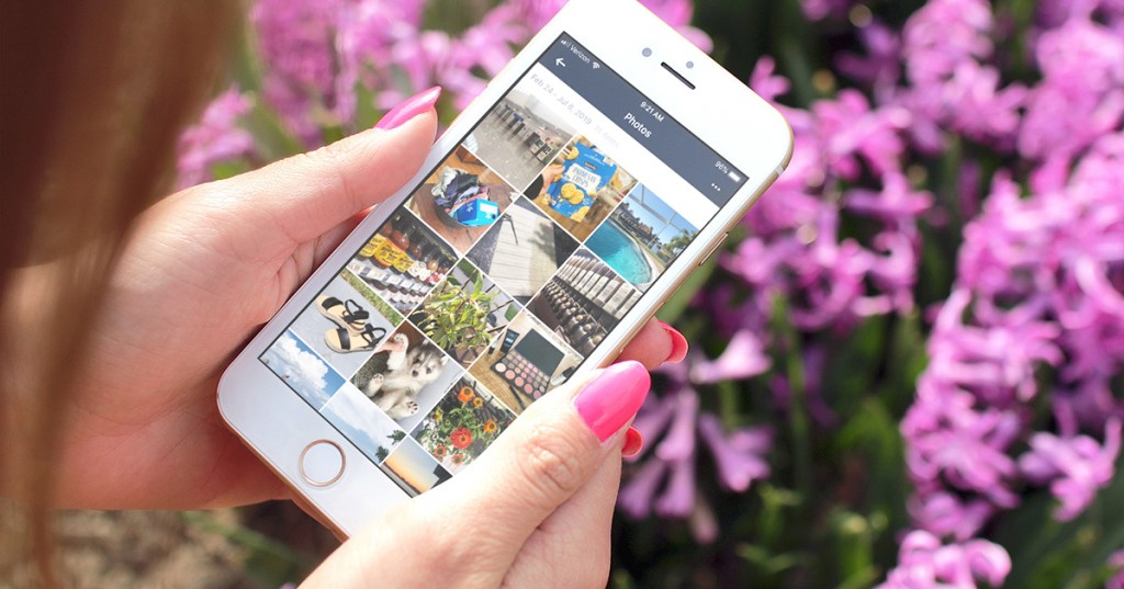 woman holding smartphone with amazon photos app