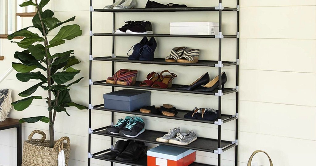 metal shoe rack with plant beside it and house siding behind it