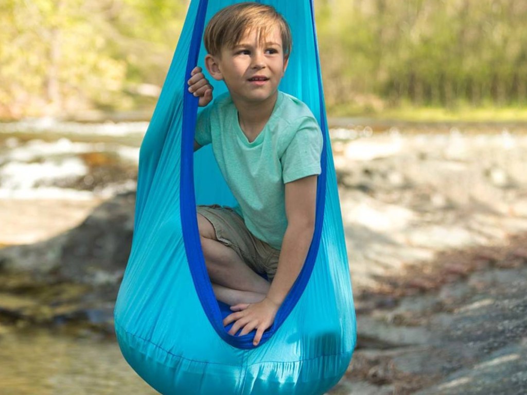 little boy sitting in blue hugglepod