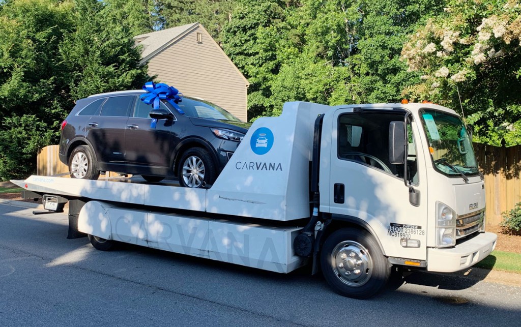 carvana car on flatbed truck