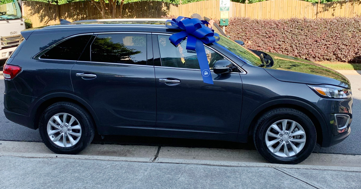 kia sorento with a big blue bow on top