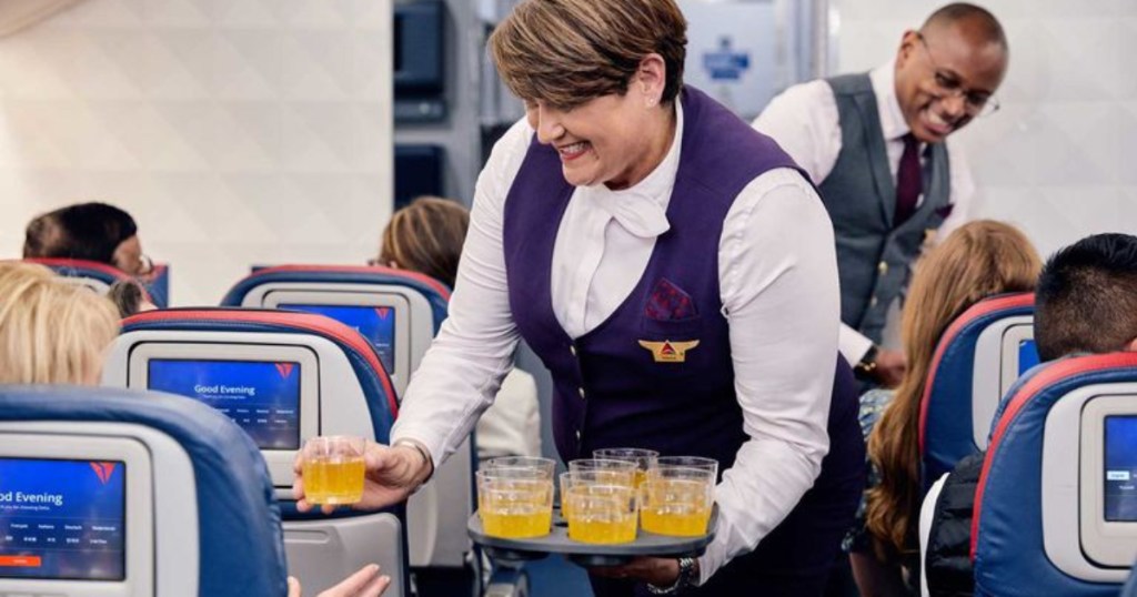 Delta flight attendant handing out cocktails