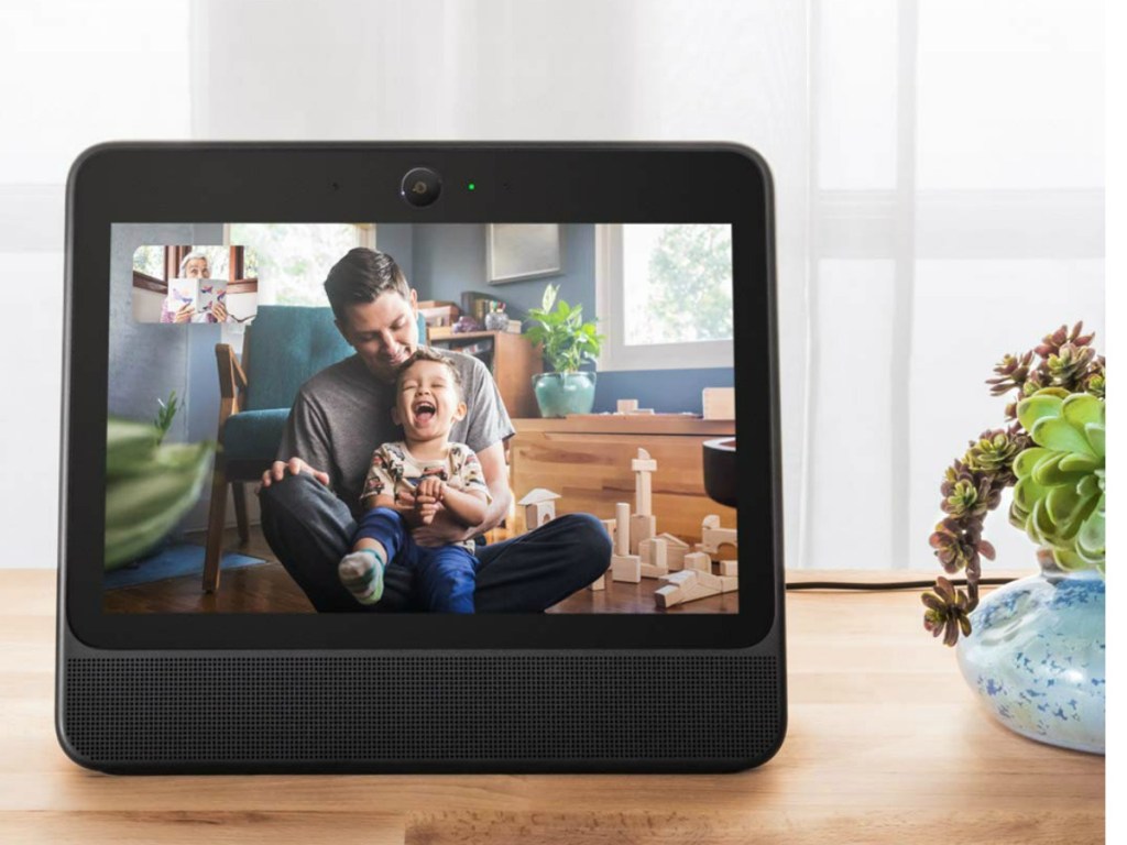 tablet on table with boy and his dad on it being filmed