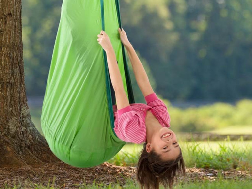 littler girl upside down in green hugglepod