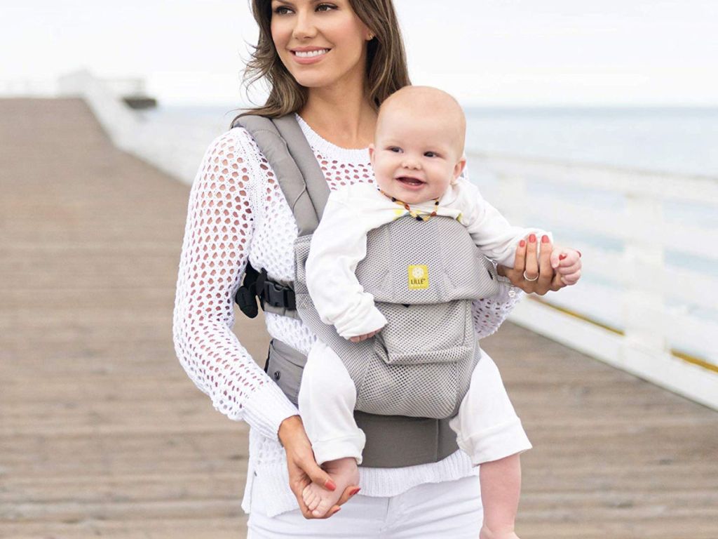 woman wearing lillebaby airflow carrier at the beach boardwalk